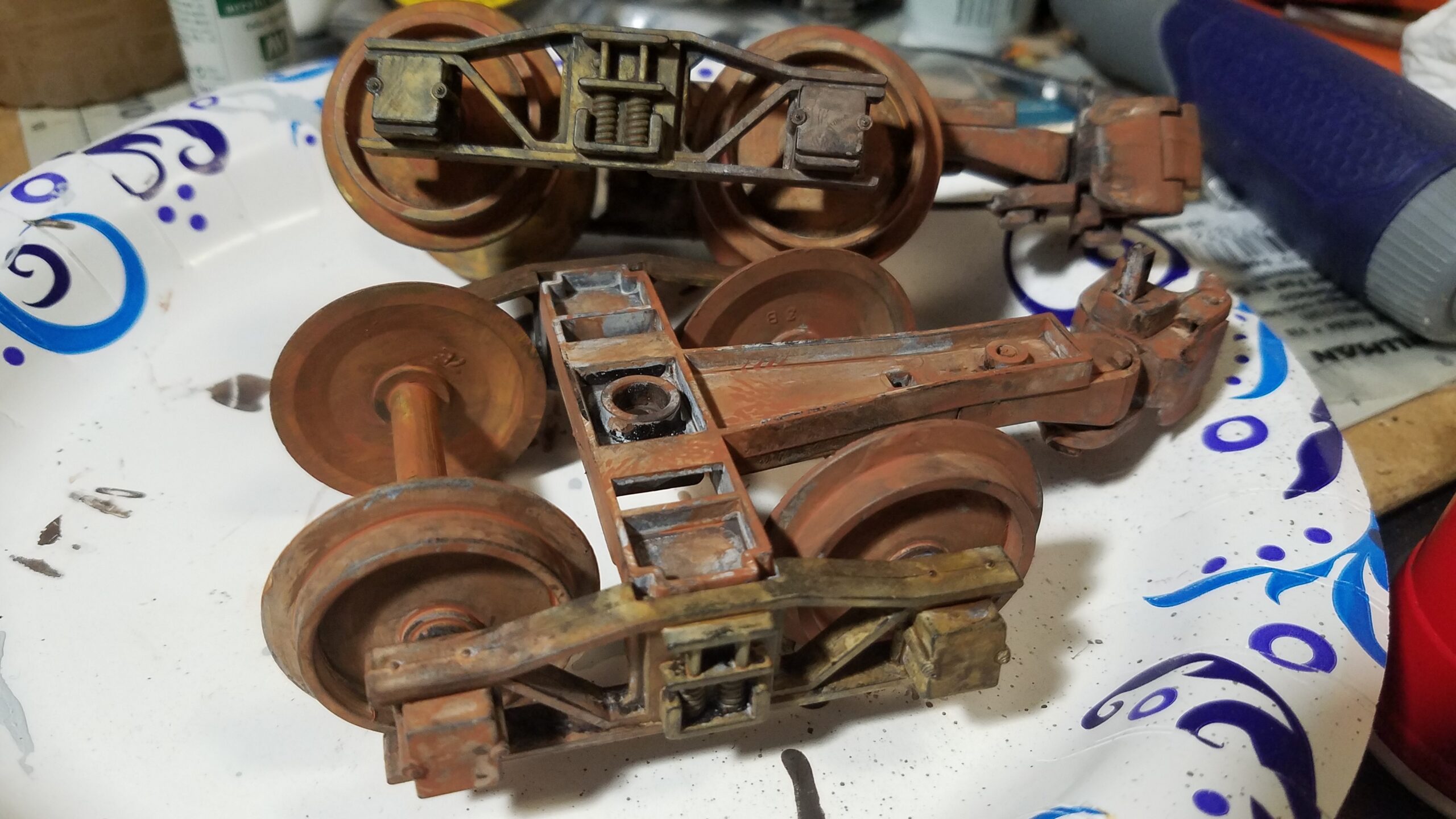 Large scale trucks and couplers weathered with rust and dirt colors