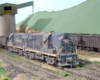 Two diesel locomotives working hopper cars at a coal tipple