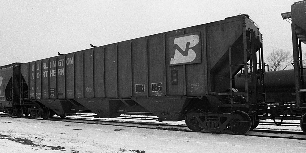 Black-and-white photo of covered hopper in a train