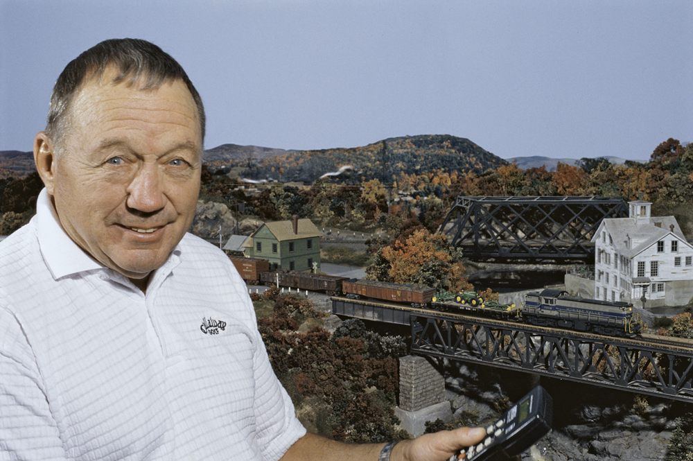Photo of man with model railroad in background