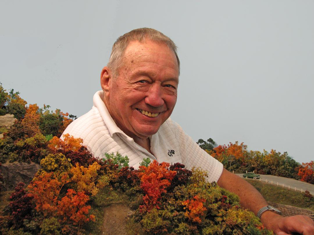 tribute to Dick Elwell: Photo of man standing in front of model railroad