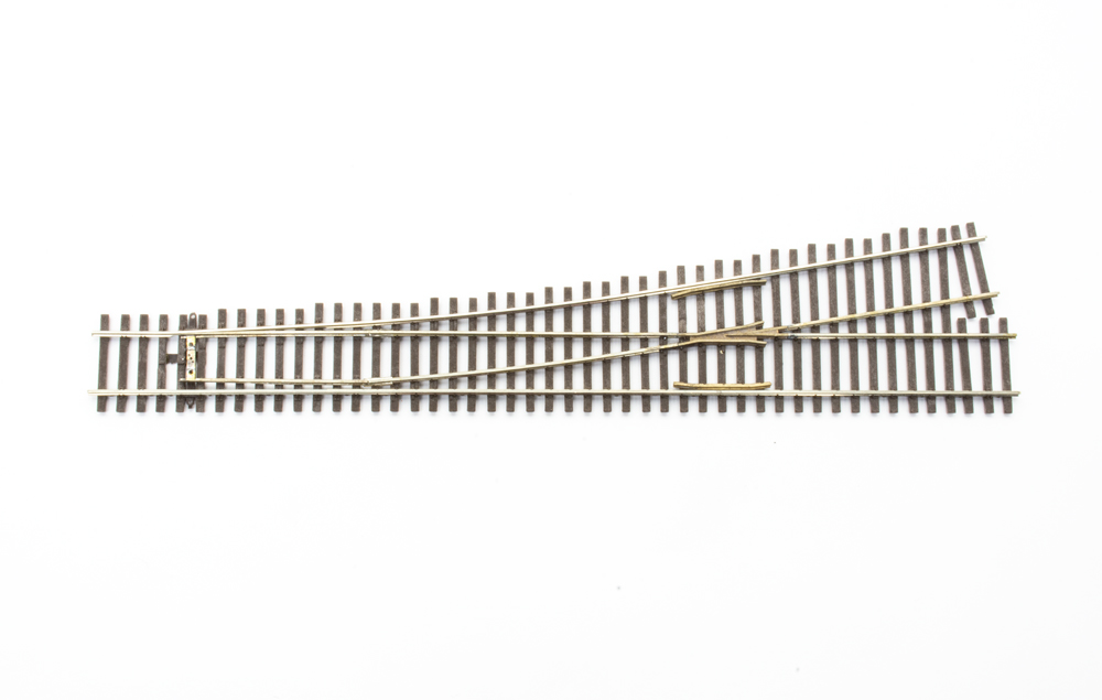 Photo of HO scale left-hand turnout on white background