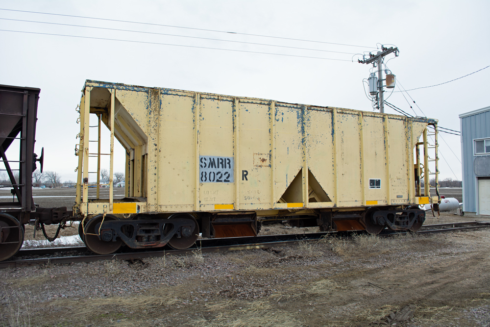 Photo of weathered ballast hopper painted yellow