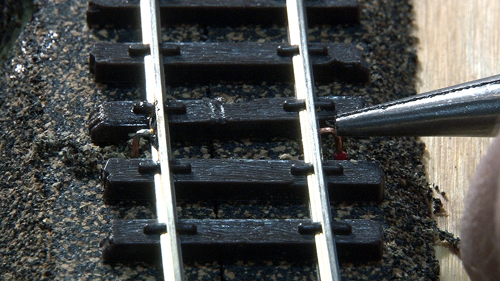Feeder wire being adjusted to fit the track.