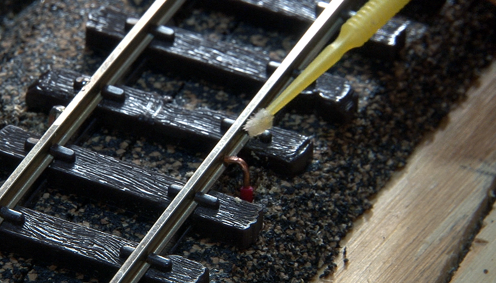 A microbrush being used to apply rosin flux.