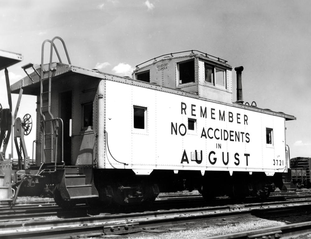 Black-and-white photo of caboose with safety slogan