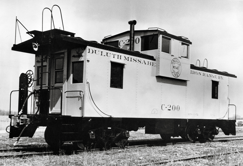 Black-and-white photo of wide-cupola caboose