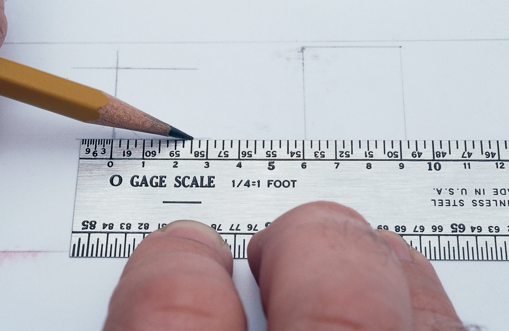 hand with pencil and scale rule