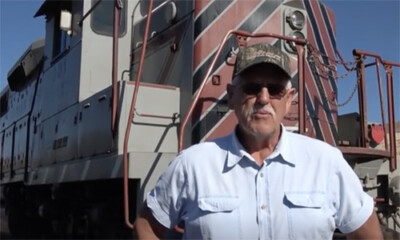 Man standing in front of a locomotive.