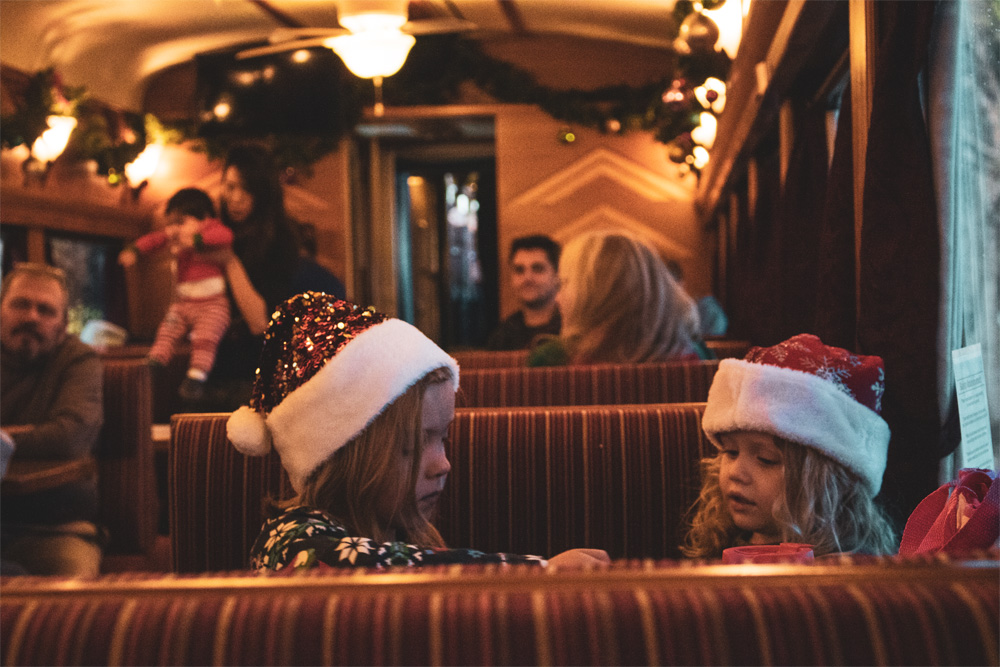 Two little girls playing on train