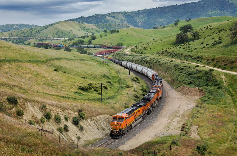 Freight train snaking through curves in mountains