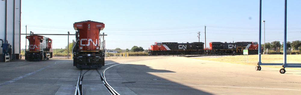 Four locomotives outside factory