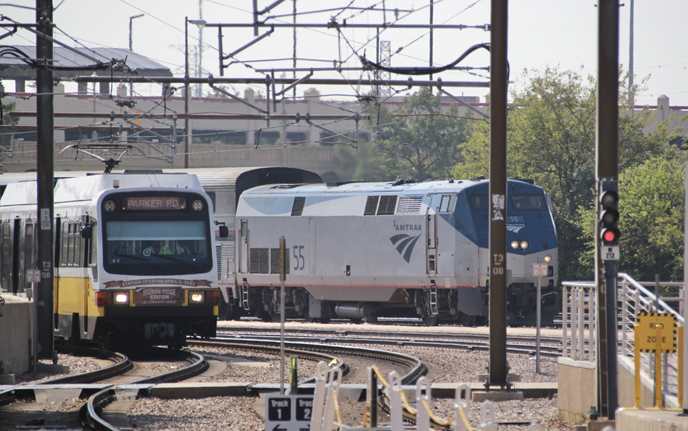 Light-rail vehicle and Amtrak train side by side