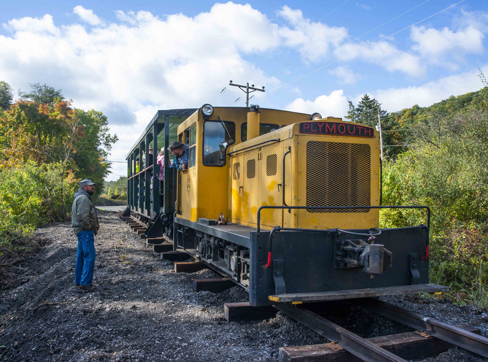 Small yellow diesel with open-air passenger car