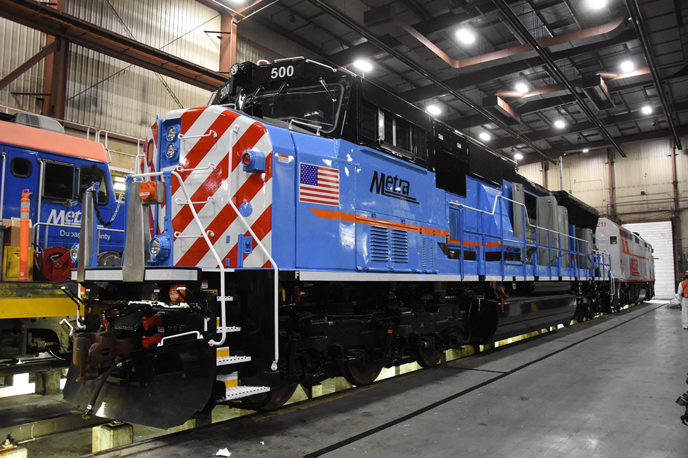 Three-quarter view of locomotive in shop building