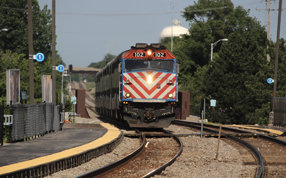 Commuter train arrives at station on curve