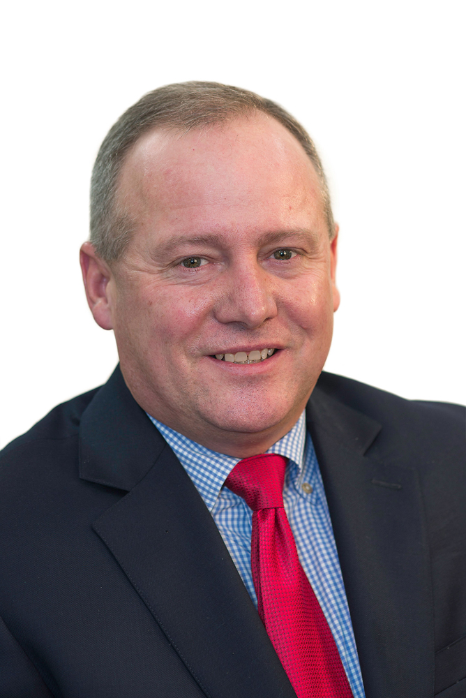 Man in dark coat with red tie