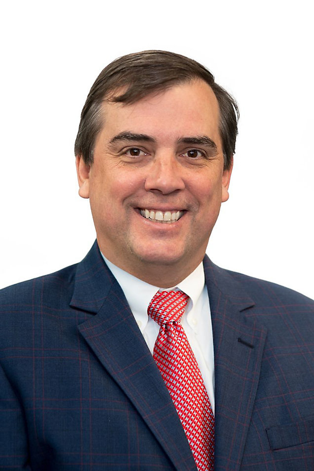 Man in dark coat and red tie