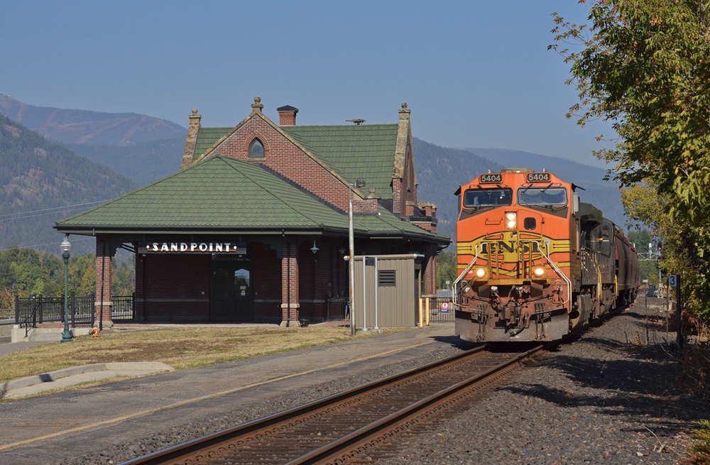 Train passing ornate passenger depot