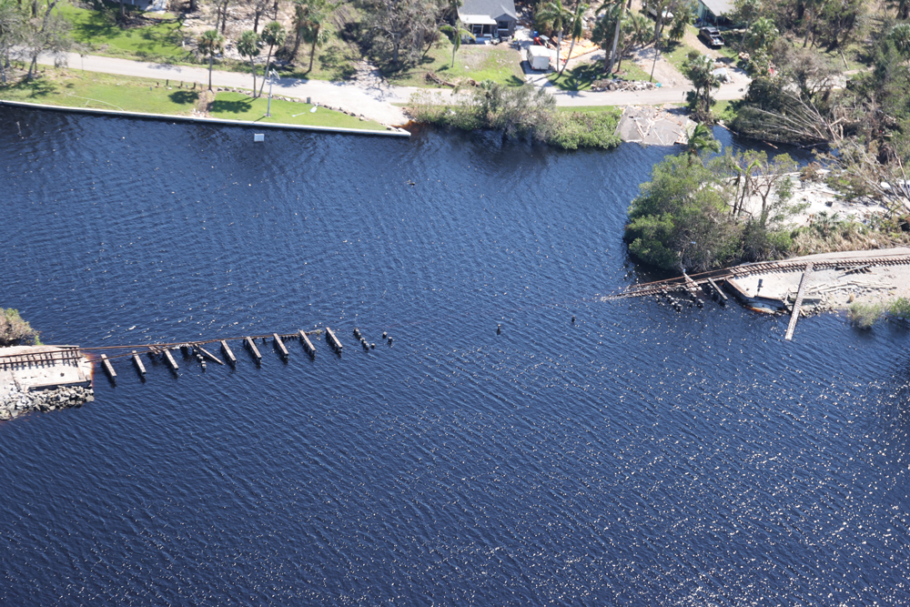 Body of water with remnants of railroad bridge visible