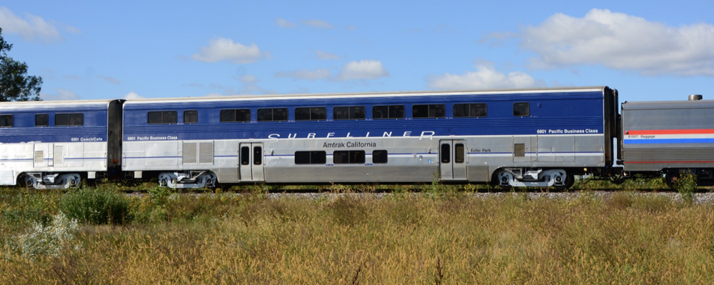 Side view of blue and silver bilevel passenger car