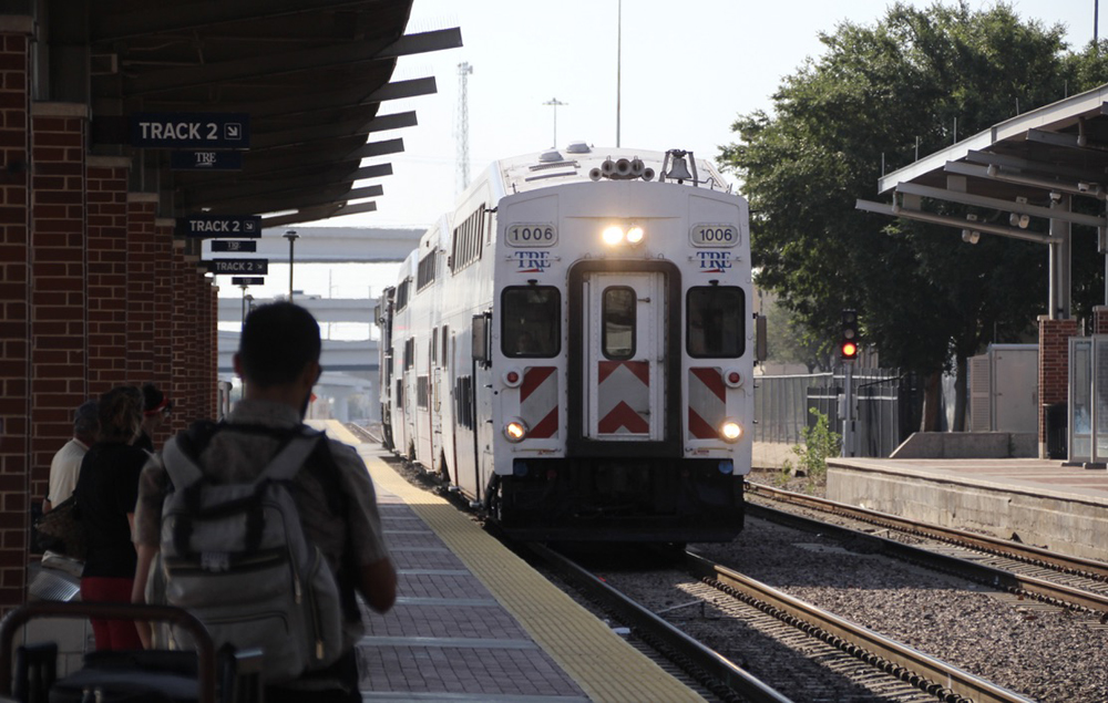 Commuter train led by cab car arrives at station