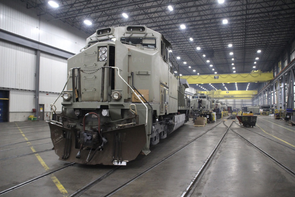 Line of locomotives in primer paint