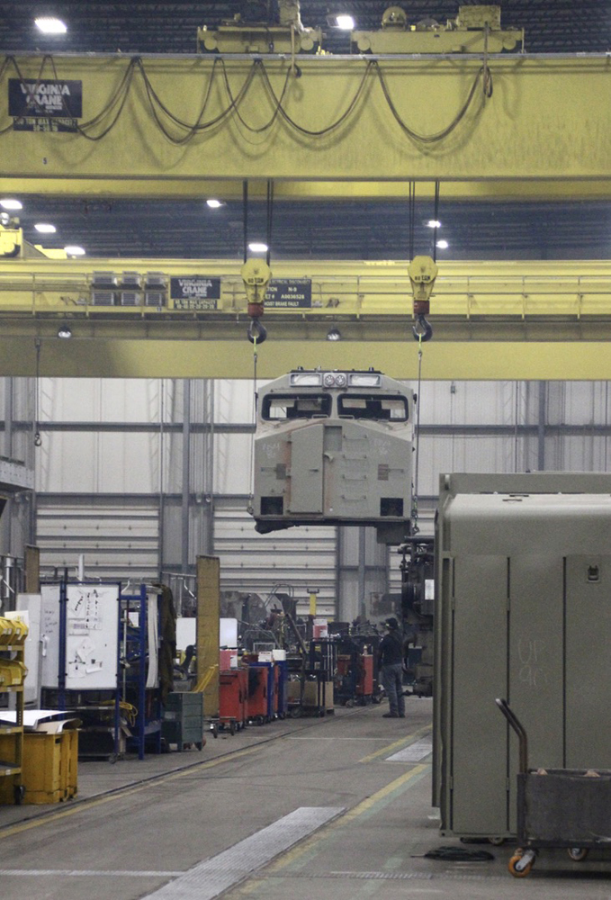 Locomotive cab being moved by crane