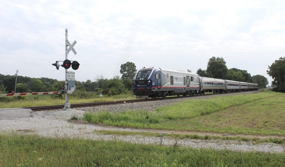 Passenger train approaching grade crossing
