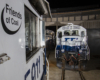 three white and blue locomotives parked