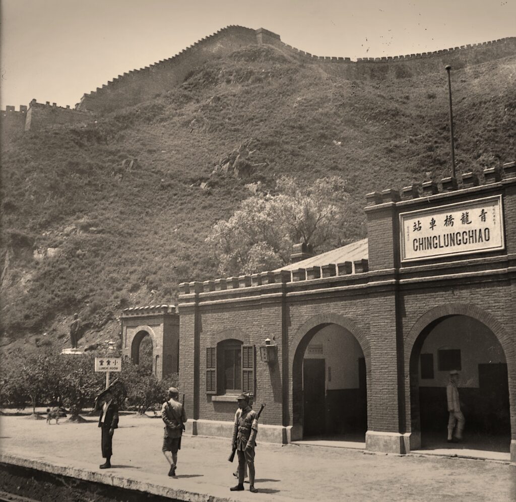 Train station in front of mountains in black and white