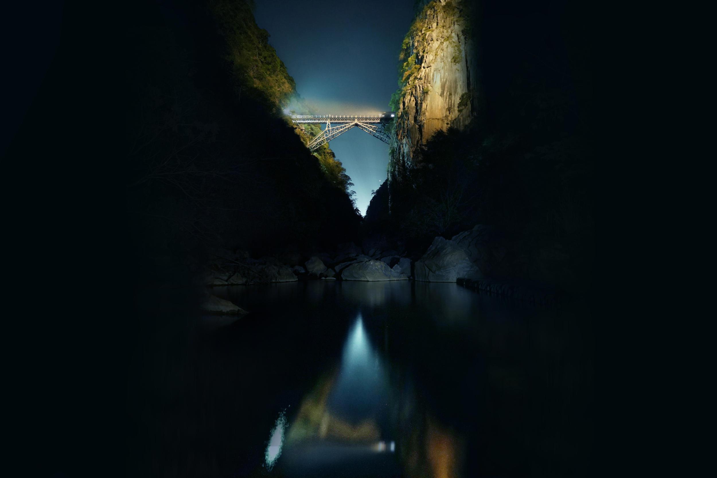 Railroad bridge over canyon and reflecting river