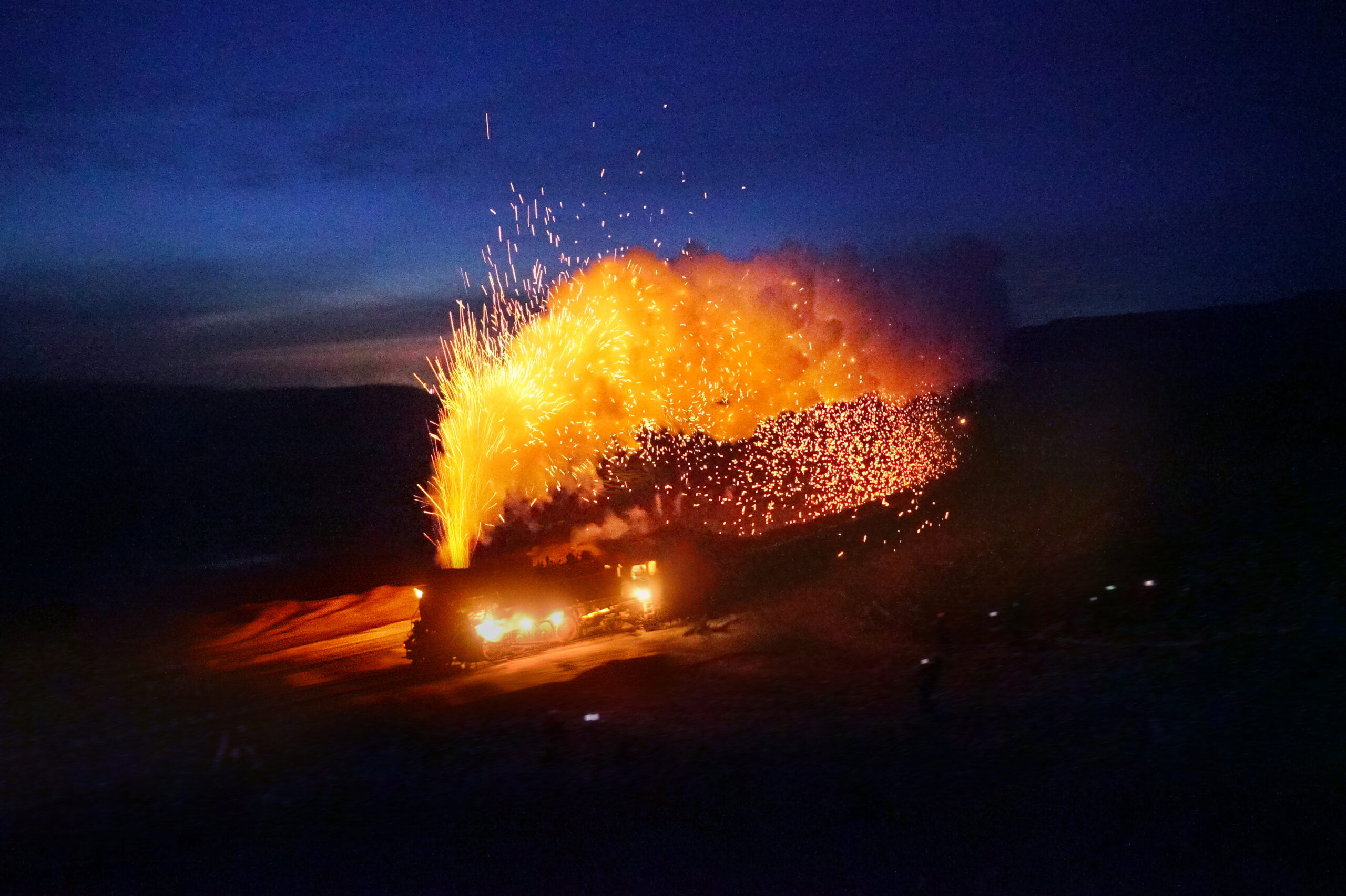 Steam locomotive running at night