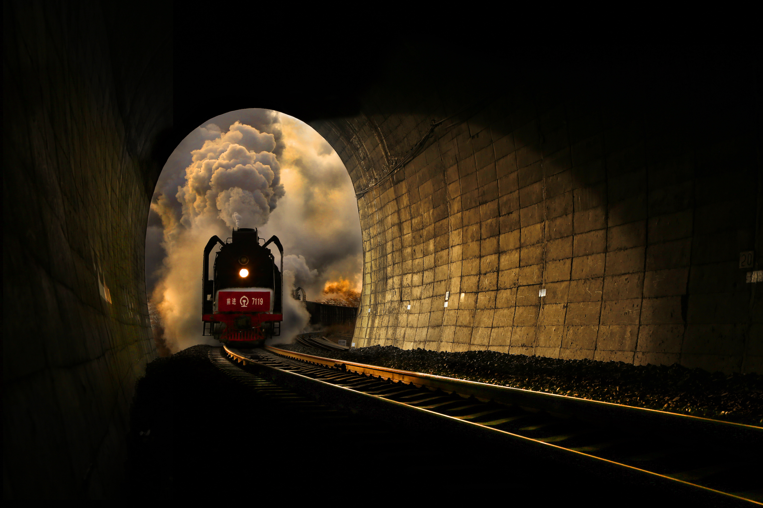 Steam locomotive entering tunnel