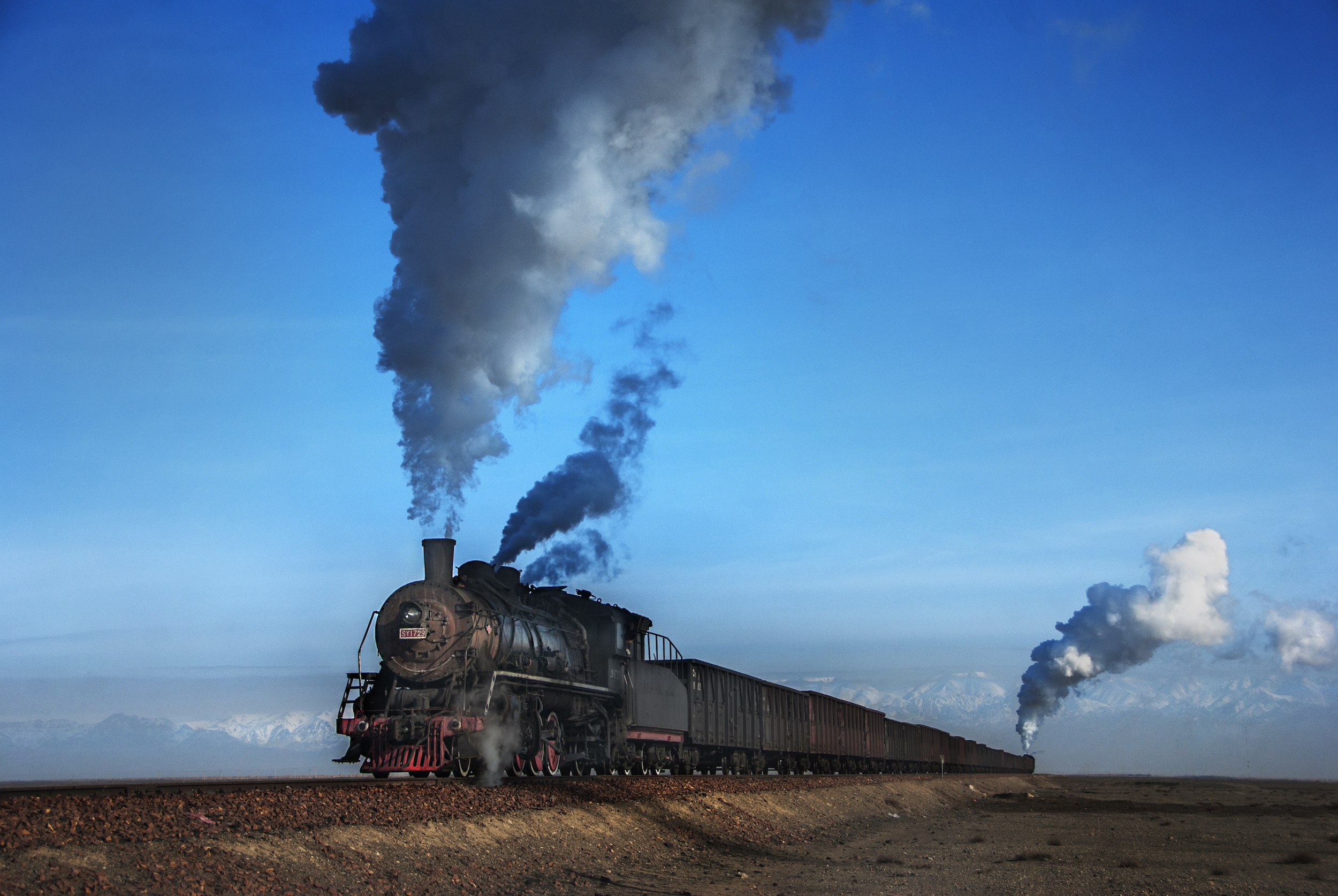 Steam locomotive pulling long freight train