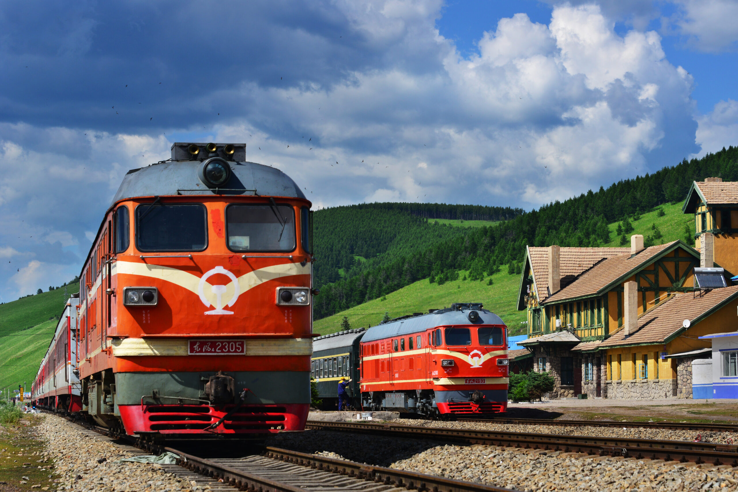 Two passenger trains at historic station