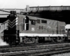 Diesel Missouri-Kansas-Texas locomotive under bridge