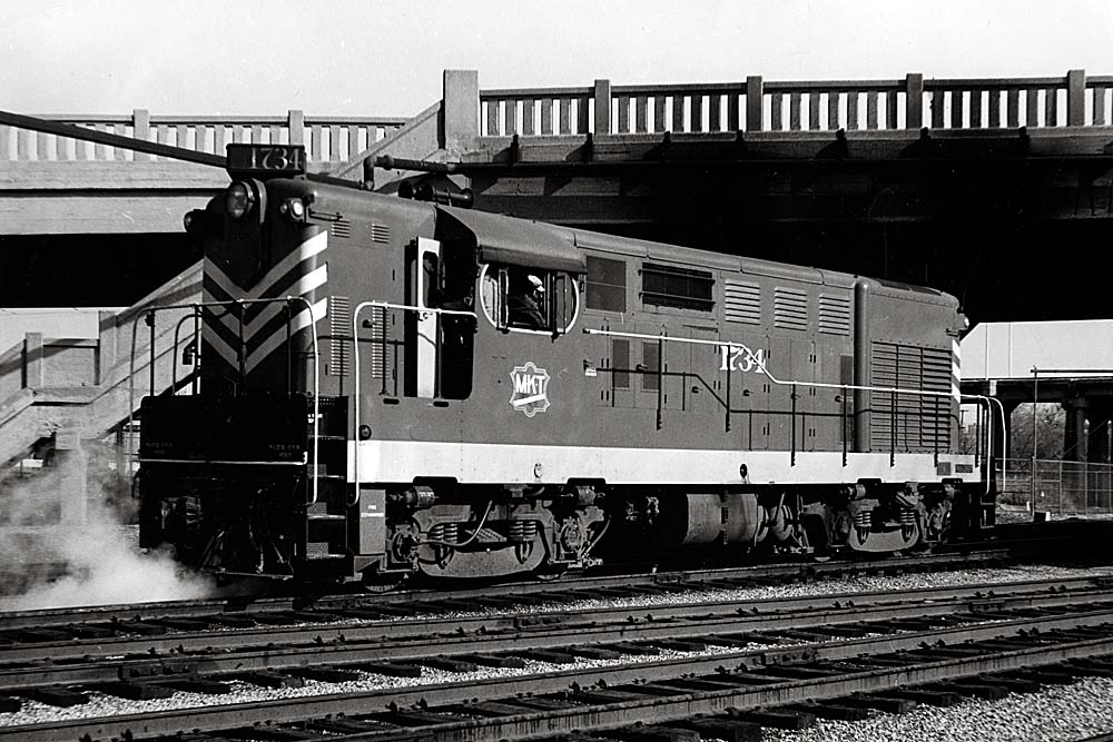 Diesel Missouri-Kansas-Texas locomotive under bridge