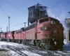 Red diesel Missouri-Kansas-Texas locomotives outside shop building