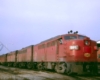 Red diesel Missouri-Kansas-Texas locomotives outside shop building