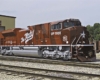 Red diesel Missouri-Kansas-Texas locomotive outside shop building