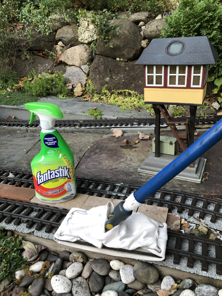 Bottle of Fantastic cleaner on garden railway with track cleaning pole