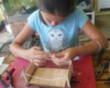 girl building wooden rolling stock