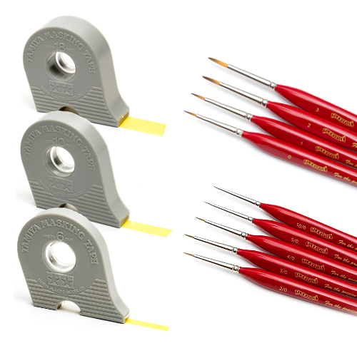 Photo of paint brushes and masking tape on white background.