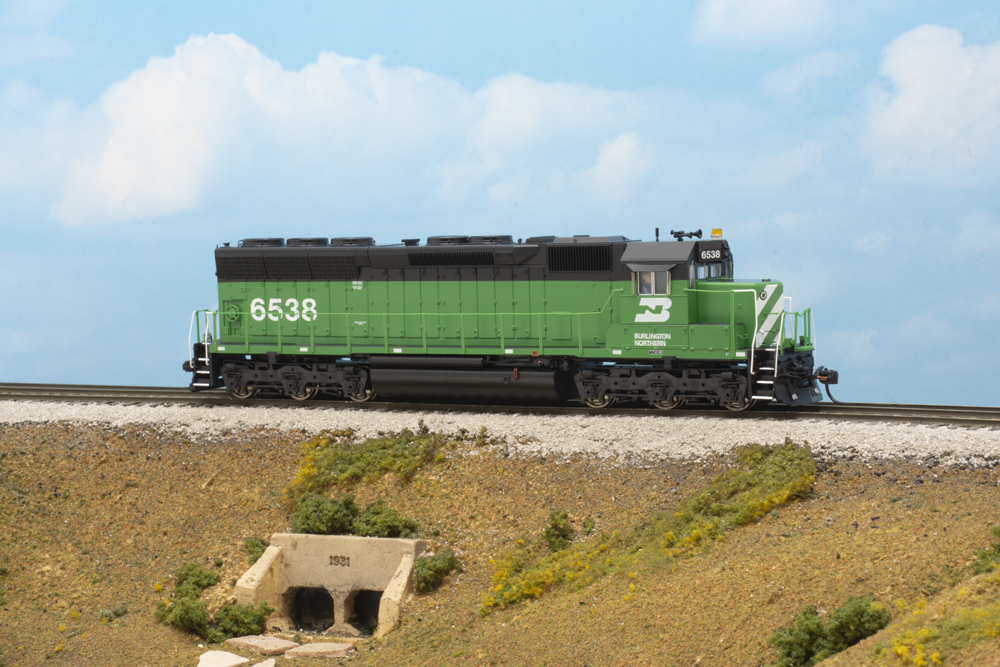 A green locomotive against a blue sky background.