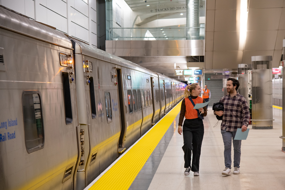 two people walking on subway terminal platform