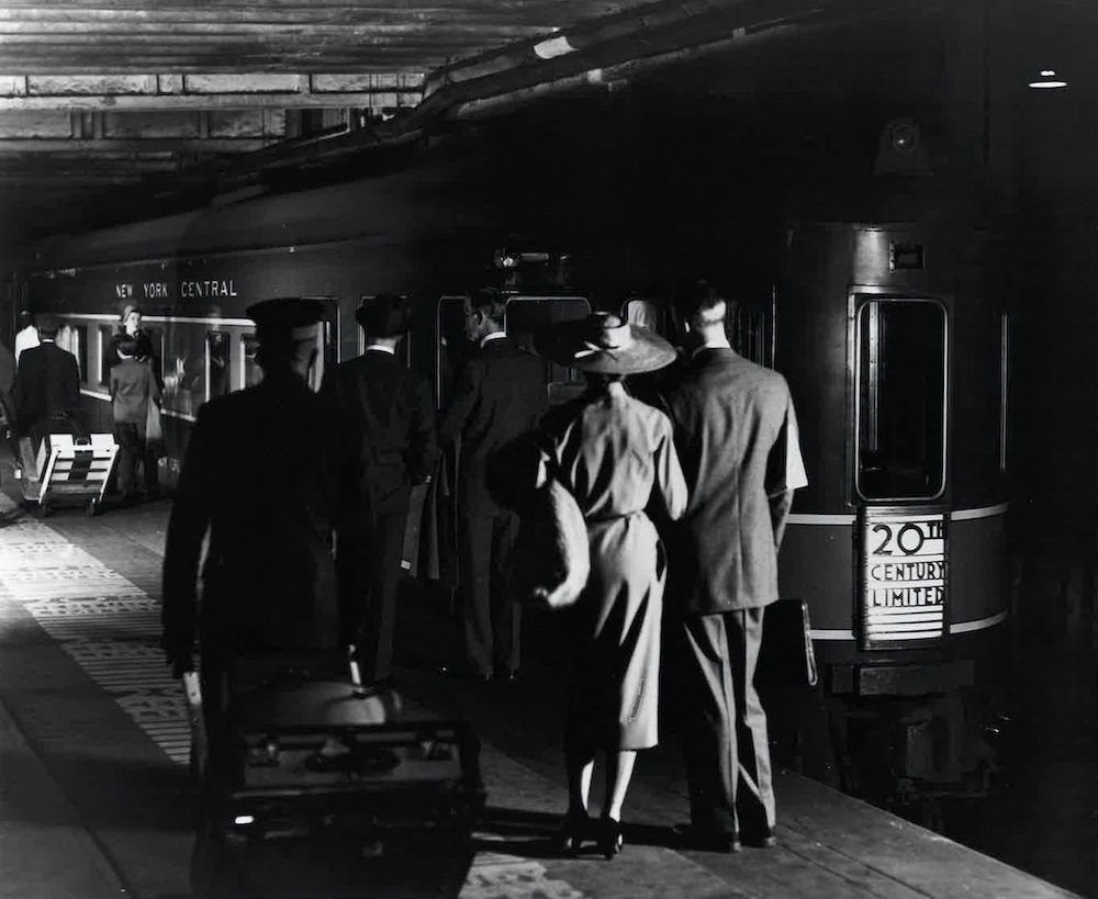 people walking past train. New York Central passenger trains