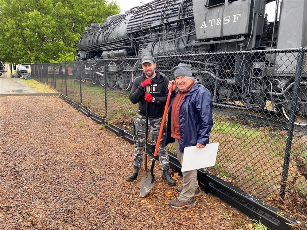 ATSF train with two guys in front of it