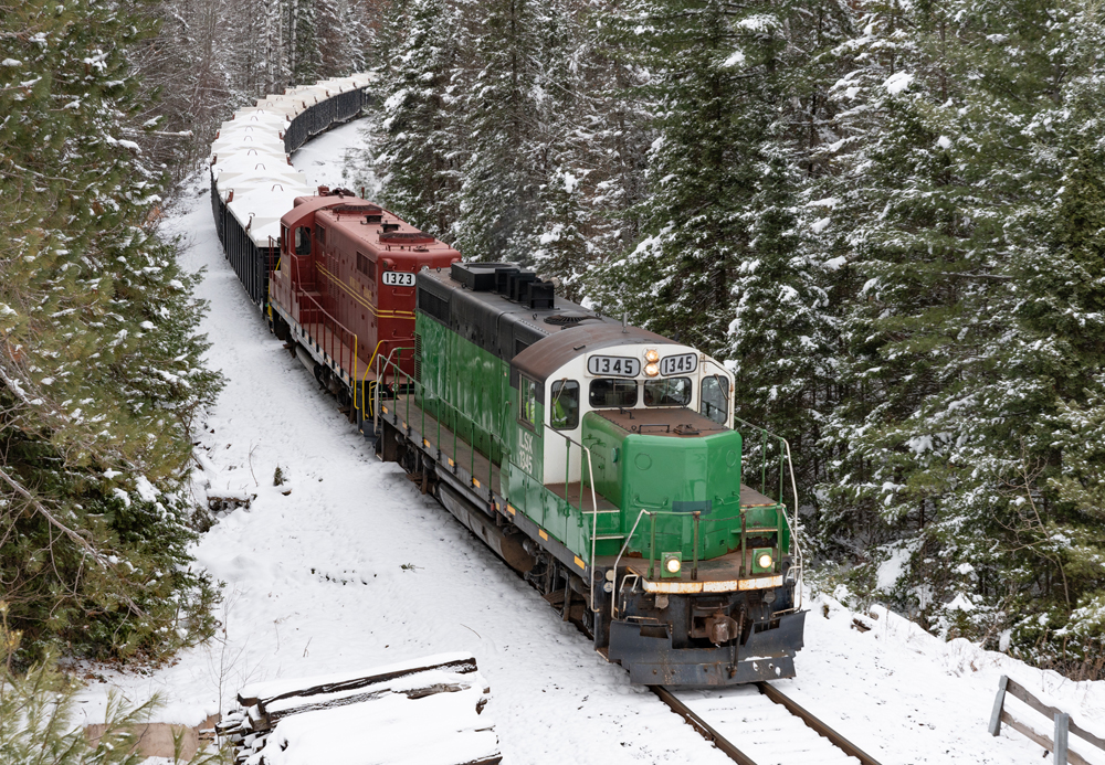 green locomotive on tracks