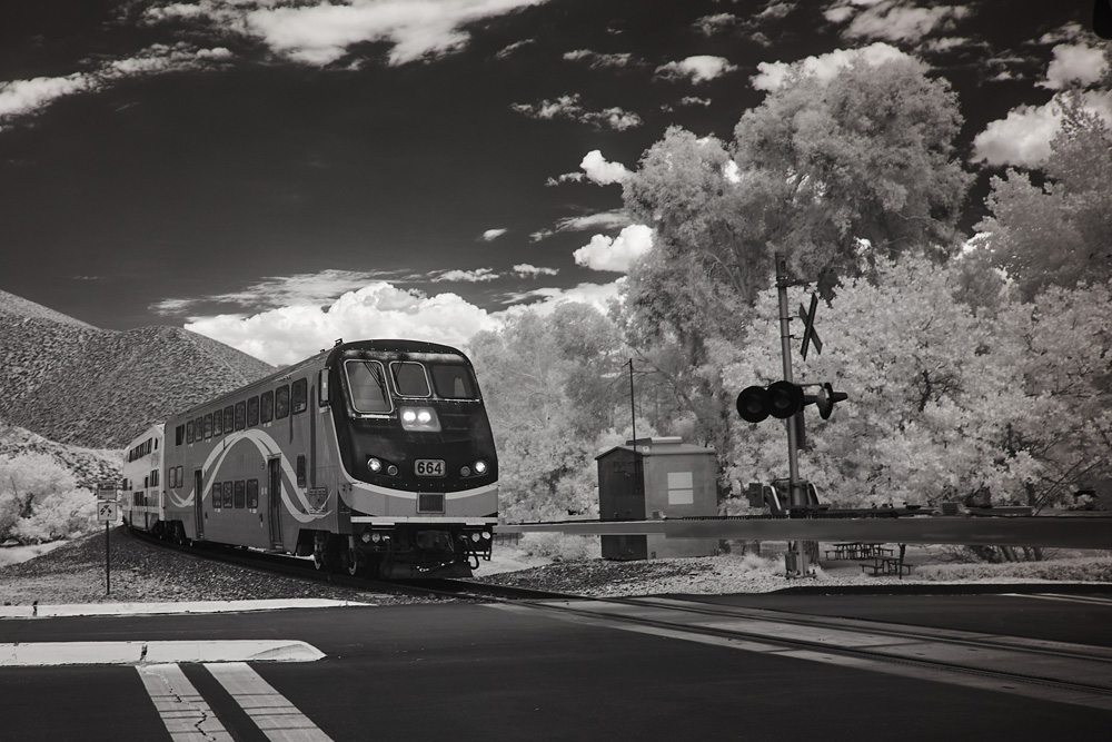 Infrared photo of train and hills in background
